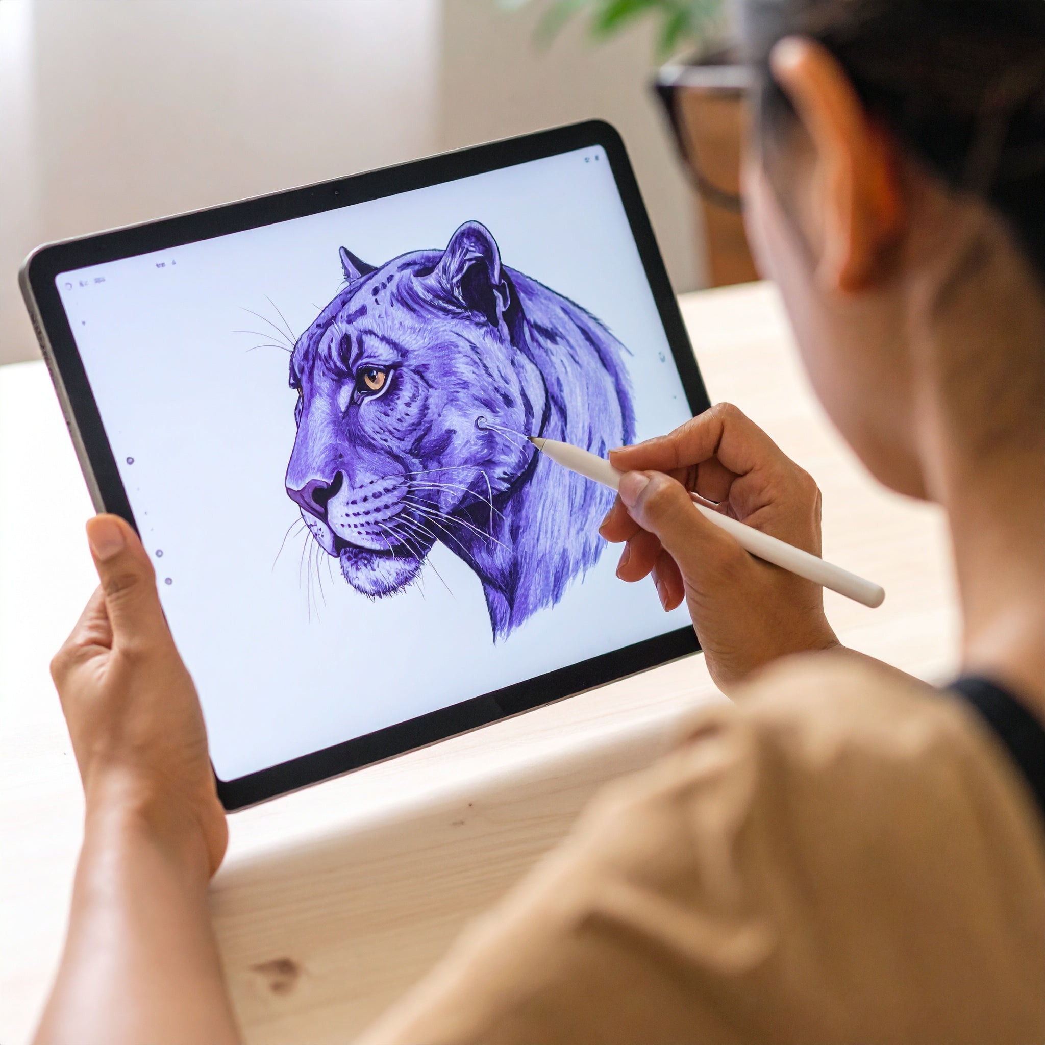 Designer on iPad drawing Purrple Panther